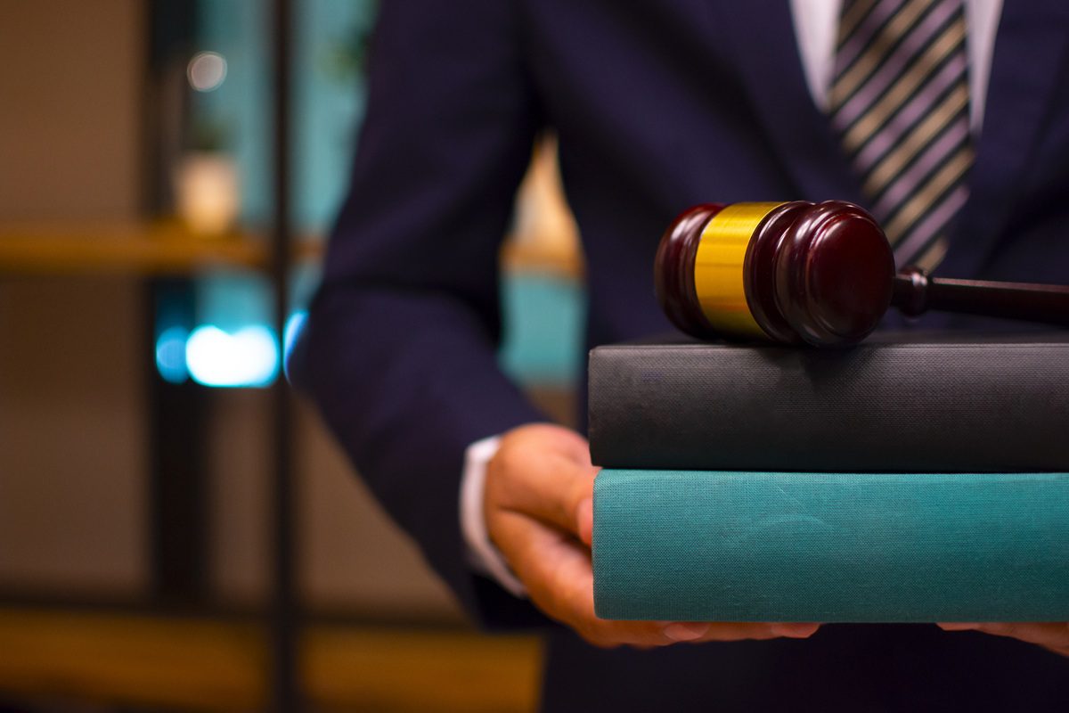 Lawyer businessman working or reading lawbook in office workplace for consultant lawyer concept.