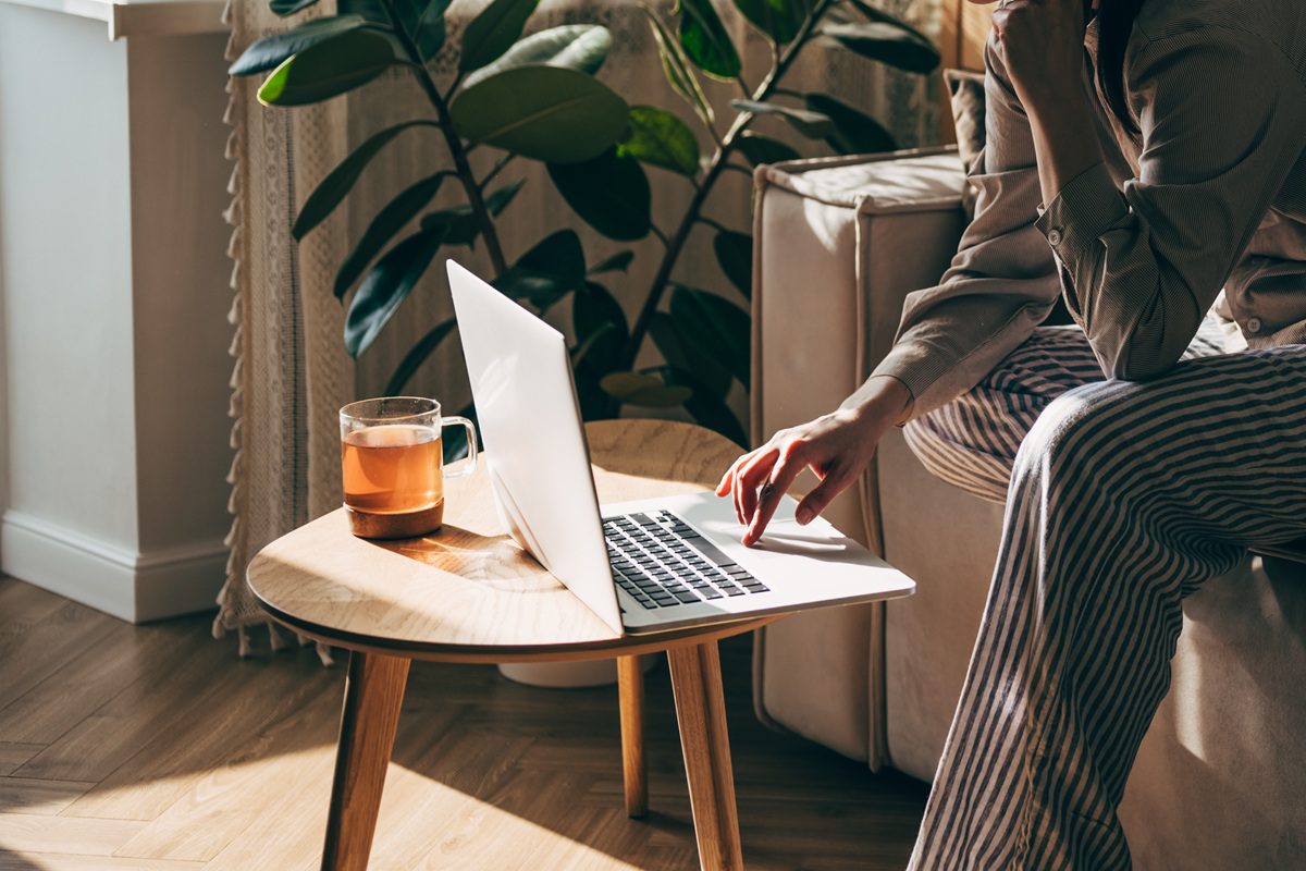 Woman, laptop or fintech phone app in house or home kitchen for finance budget, investment accounting or insurance taxes. Thinking mature person with technology, paper or document for retirement loan