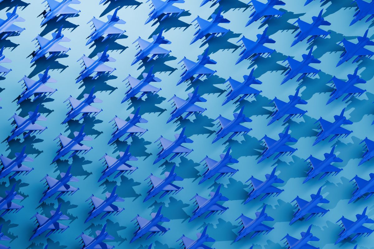 A conceptual image featuring a clean, evenly spaced grid pattern filled with stylized, block-colored fighter planes in bold blue tones. The visual evokes themes of coordination, power, and aerial strategy, with the repeated plane shapes suggesting organized force, tactical readiness, or mass deployment. The minimalist grid composition highlights ideas of control, uniformity, and calculated strength—ideal for visuals related to military strategy, air dominance, defense technology, or abstract representations of power and precision.