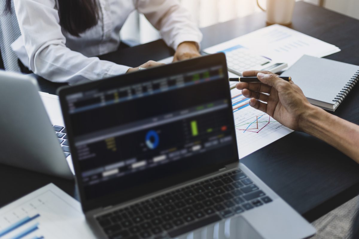 Accountants working on financial statement on laptop screen in office. Business consulting meeting working and brainstorming new business project finance investment concept.