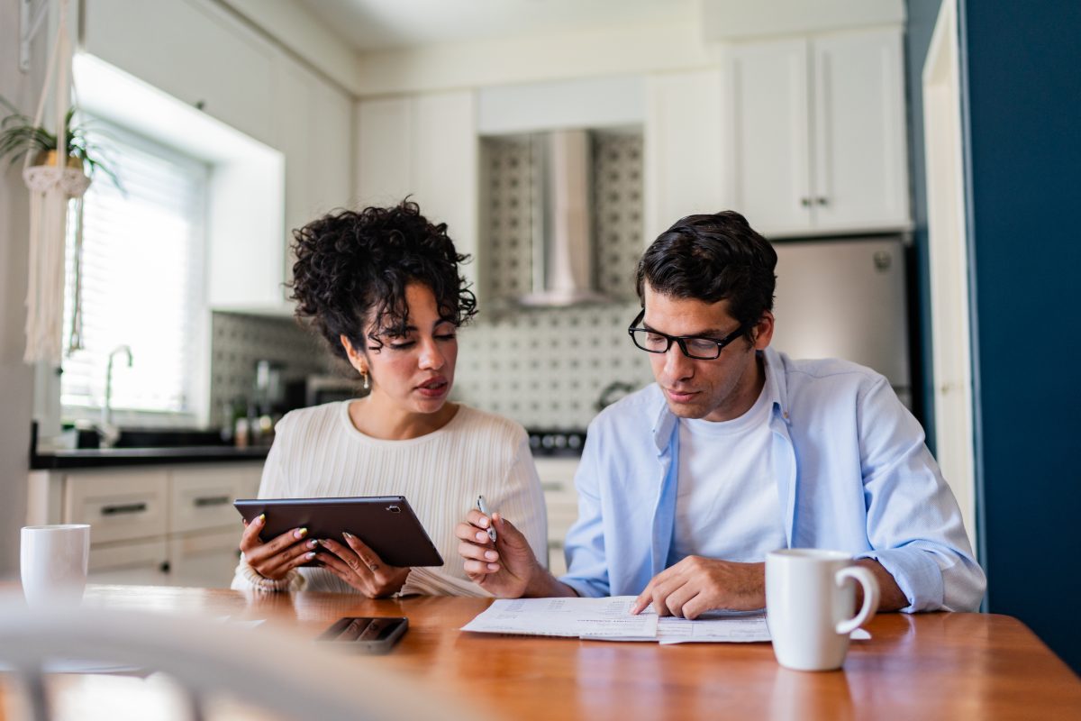 Young couple talking while doing home finances