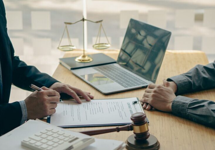Businessmen seek advice from lawyers for good service cooperation. Judges with team meetings with clients Legal concepts and hammer and scales of injustice contract documents in the office - stock photo