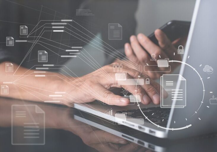 Database directory, E-document, paperless office concept. Business man working on laptop computer with electronic document on virtual screen