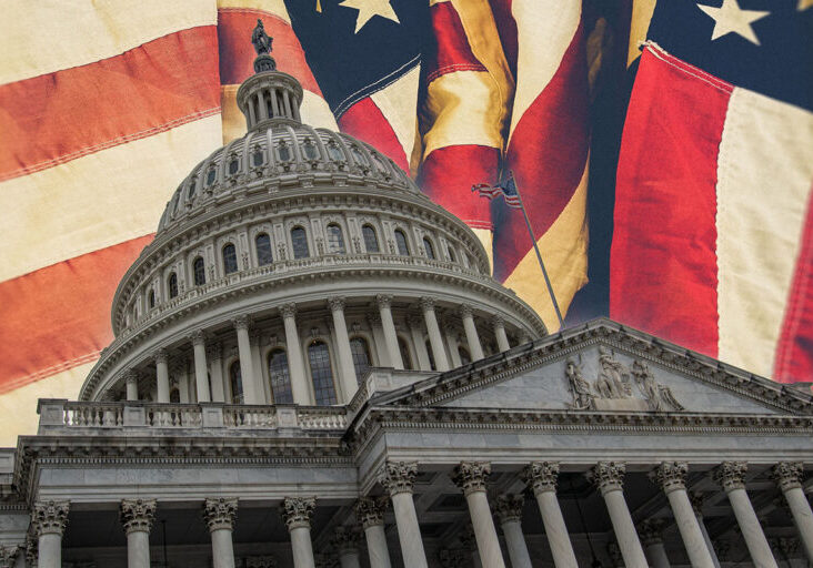 Government building against a background of US flags