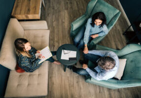 Three persons talking in the office