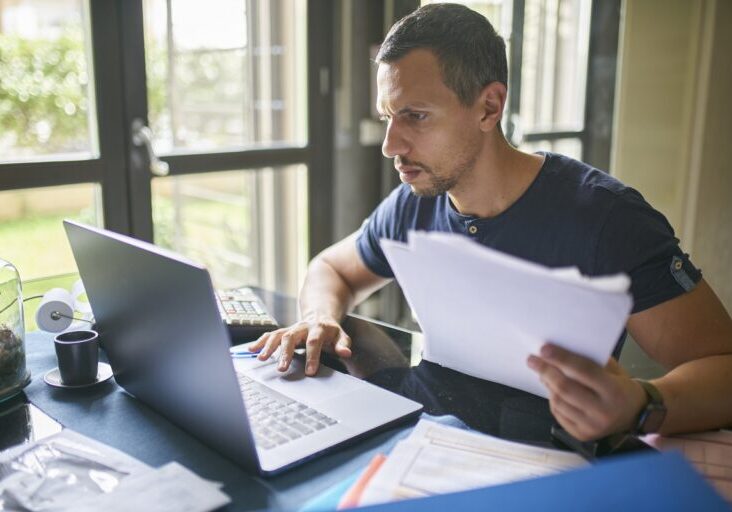Man preparing his taxes at home