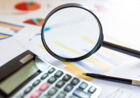 Analysis data information with magnifying glass and calculator