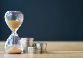 Time and stack of coins.