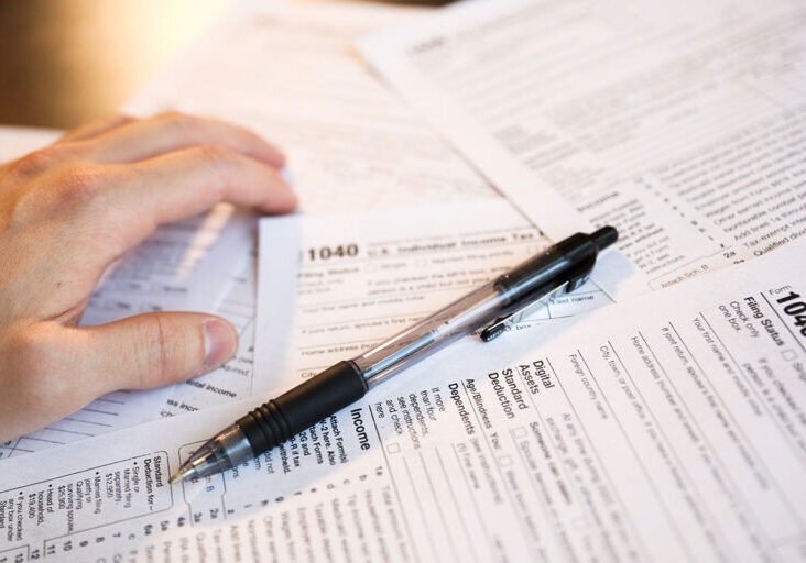 Tax paperwork for internal revenue service IRS showing financial accounting 1040 documents showing time for payment and deadline for refund time and declaration of financial debt and profit balance