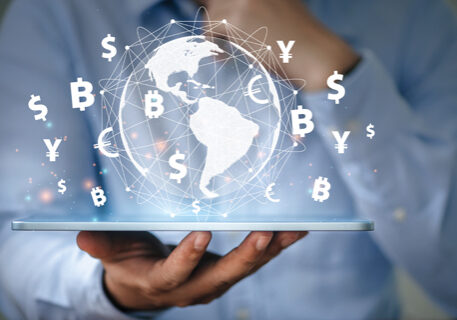 business man uses a tablet visualizing global currency