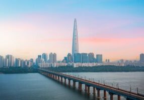 South Korea's Gyeonggi Province Bridge Over a River with Buildings Against the Sky