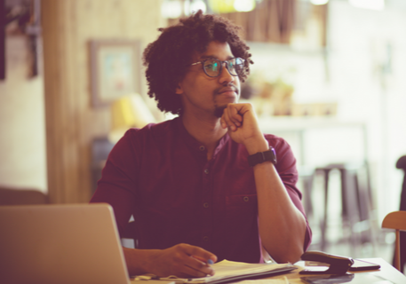 Man in glasses contemplating a decision