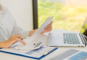 Accountant or Financial Auditor, Reporting, Computing, Home Finance, Investing, Economy, Savings, Businessman or Financial Professional. Analyze graphs, business reports and financial charts at the company office. financial economy concept banking busines