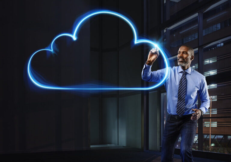 Businessman painting cloud with light