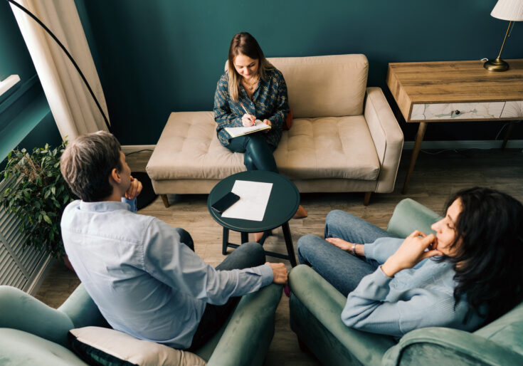 Three persons talking in the office