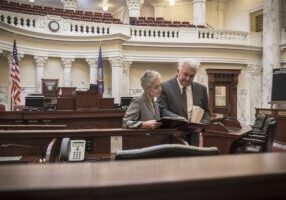 Caucasian politicians talking in capitol building