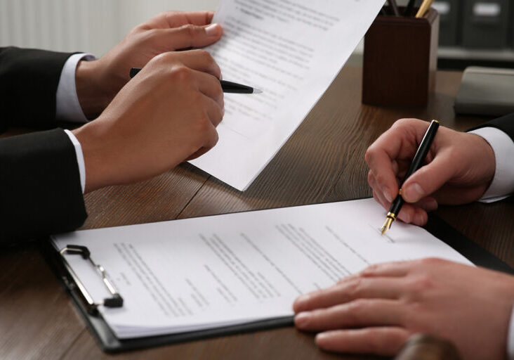Law and justice. Lawyers working with documents at wooden table, closeup - stock photo