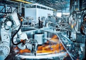Robotic arms operating inside modern factory - stock photo