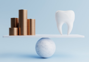 Dental tooth and golden coin on balancing scale on blue background.