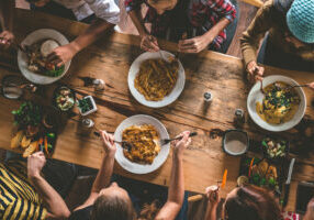 Group of happy friends having nice food and drinks, enjoying the party and communication, Top view of Family gathering together at home for eating dinner