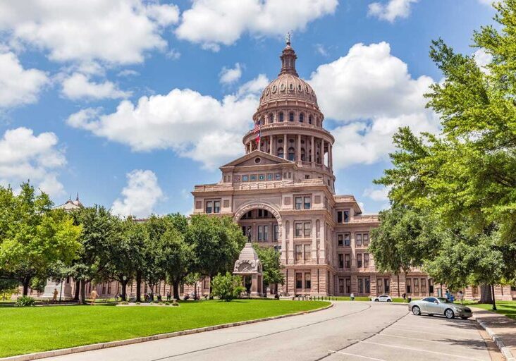 Texas State Capitol building in Austin, Texas, the USA. Blue cloudy sky.