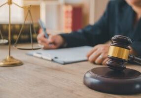 Law theme, mallet of the judge, law enforcement officers, evidence-based cases and documents taken into account.