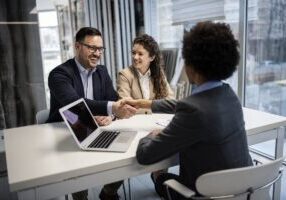 Young business couple signing a contract