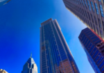 Urban-building-bottom-up-view-with-a-clear-blue-sky-150x150