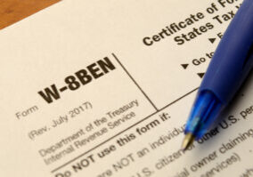 A macro shot of a blank W-8BEN form to fill out for selling copyrighted material in the USA and reduce any taxes held.