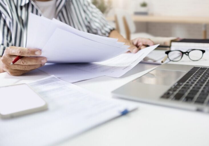 Asian man entrepreneur working at home checking about business document, report and business contract before start new business