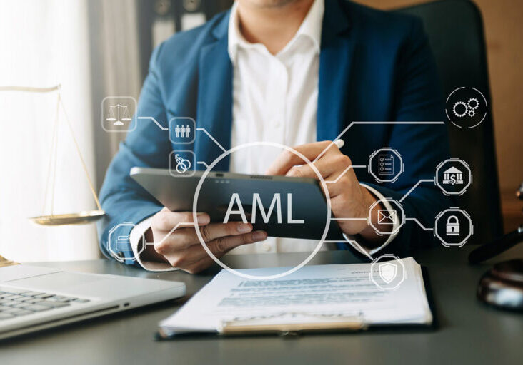 AML Anti Money Laundering Financial Bank Business Concept. judge in a courtroom using laptop and tablet with AML anti money laundering icon on virtual screen. - stock photo