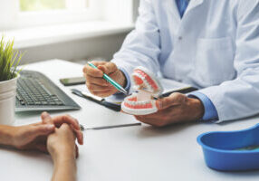 dentist and patient discussion about planned teeth treatment in dental clinic office