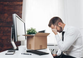 Businessman clearing his desk after being laid off