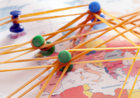 map of europe with thumbtacs and rubber bands