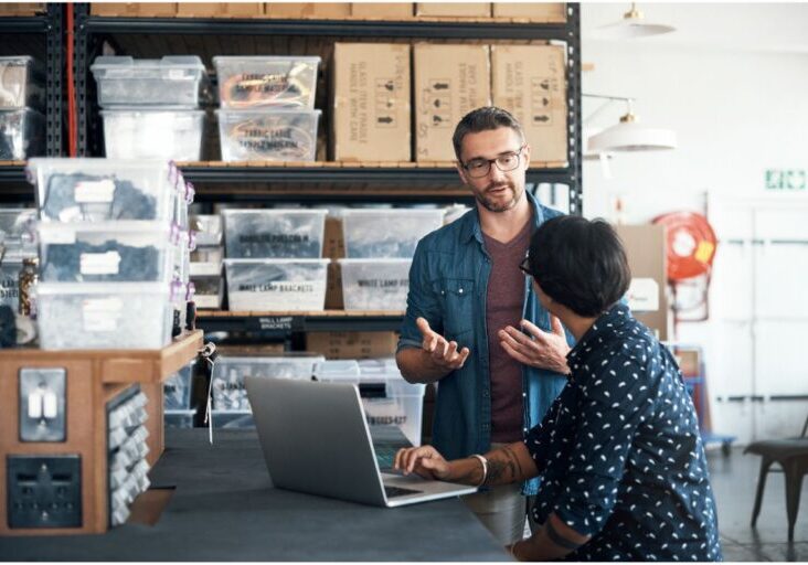 Shot of a man and woman having a discussion in a workshop