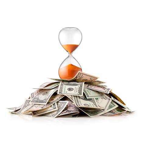 Heap of money with hourglass Heap of dollar bills with hourglass.